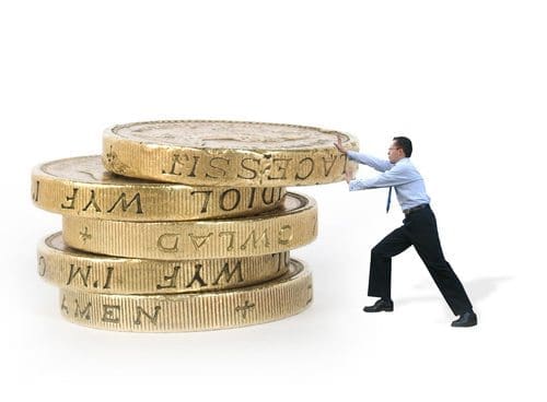 business man pushing coins – power
