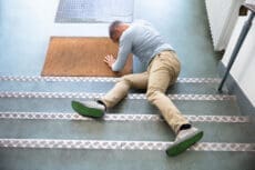 Mature,Man,Lying,On,Staircase,After,Slip,And,Fall,Accident