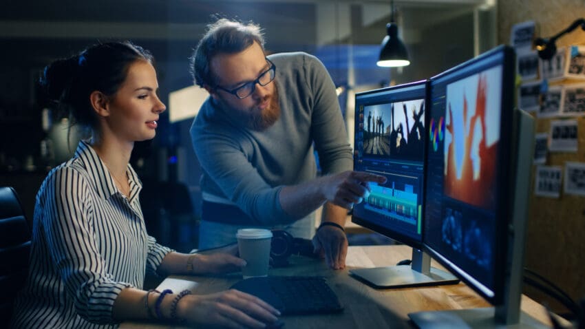 Female,Video,And,Sound,Editor,Works,With,Her,Male,Colleague