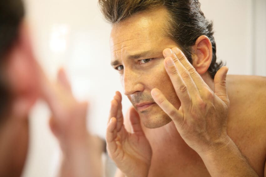 Middle-aged,Man,In,Bathroom,Applying,Facial,Lotion