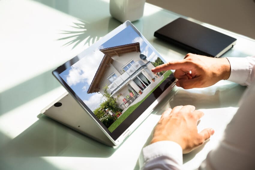 Close-up,Of,Businessman’s,Hand,Checking,House,On,Laptop